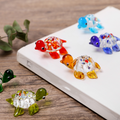 Six handmade tiny glass turtle ornaments by Everything Baby, colorful hand-blown turtle figurines for decor and collectibles.