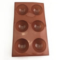 Silicone hot chocolate cocoa bomb mold with six semi-ball cavities, ideal for making holiday or Valentine’s DIY chocolate spheres.