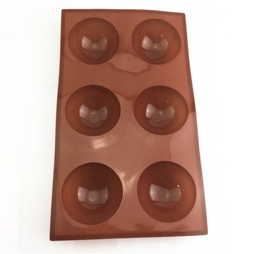 Silicone hot chocolate cocoa bomb mold with six semi-ball cavities, ideal for making holiday or Valentine’s DIY chocolate spheres.