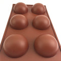 Silicone hot chocolate cocoa bomb mold with 6 large semi-spherical cavities, ideal for DIY holiday and Valentine's treats.