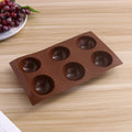 Silicone hot chocolate cocoa bomb mold with six large semi-sphere cavities, ideal for DIY holiday and Valentine’s treats.