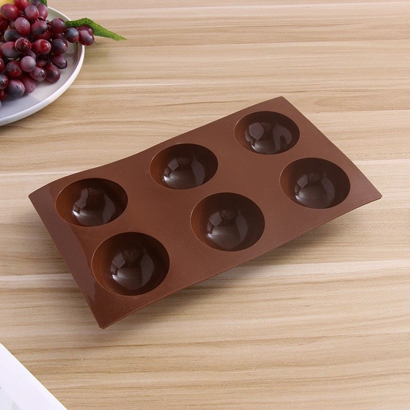 Silicone hot chocolate cocoa bomb mold with six large semi-sphere cavities, ideal for DIY holiday and Valentine’s treats.