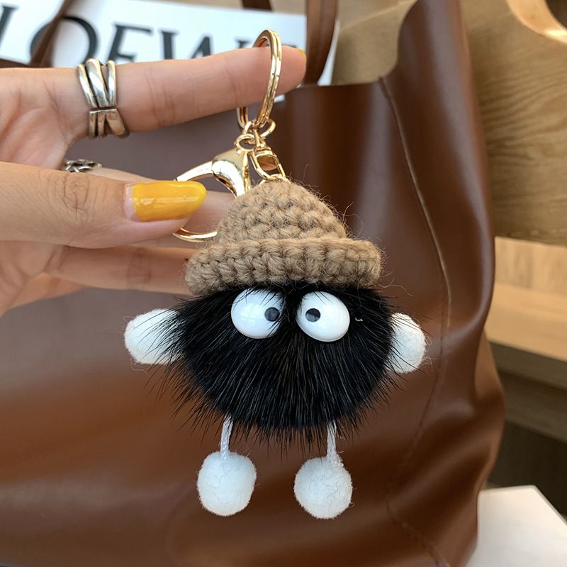 Fluffy woolen plush keychain with soft ball design, ideal for bags and backpacks, by Everything Baby, featuring cute, colorful weaving.