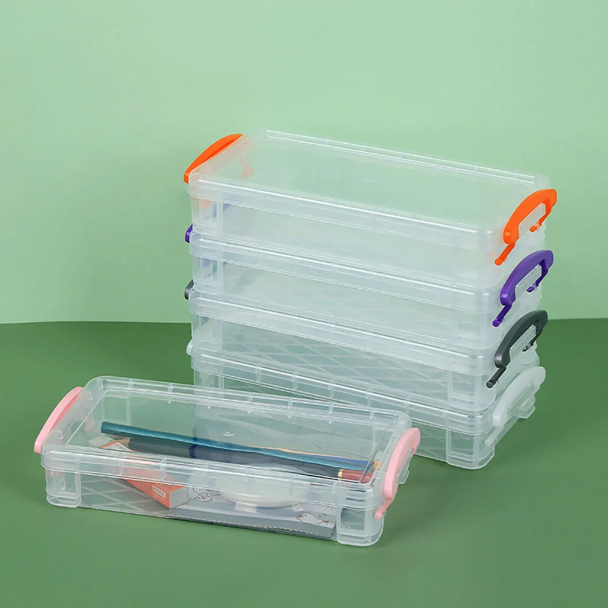 Large clear plastic pencil case with snap-tight lid, ideal for storing crayons, markers, and pens for kids.