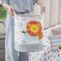 Kids toy storage basket with 3D lion design, foldable cotton canvas hamper with handles and drawstring for nursery organization.