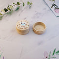 Natural wooden tooth fairy box with printed lid and mini tweezers, designed for kids' baby teeth storage, beige small size.