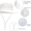 White baby sun hat with wide brim, lightweight breathable cotton, foldable beach bucket hat for boys and girls 0-8 months.