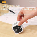 Black bucket timer with rotating dial displaying 5, 10, 30, 60-minute options and custom countdown, used for baby changing routines.