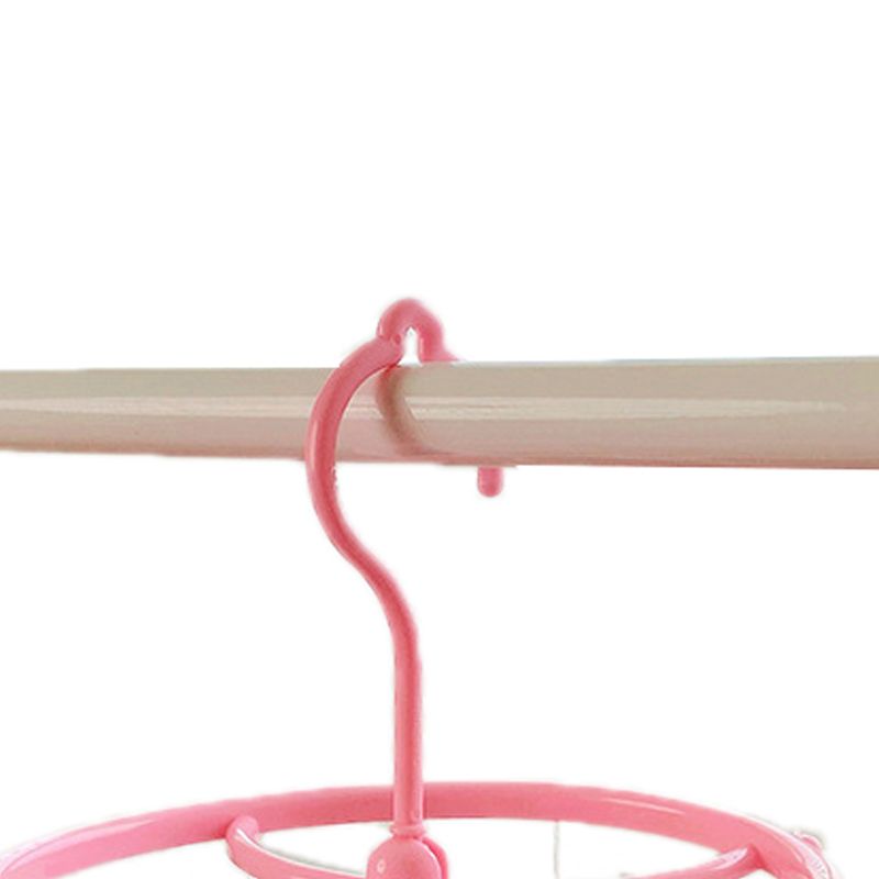 Pink plastic hanging drying rack with small cloth clips for socks and underwear, ideal for home or dormitory use.