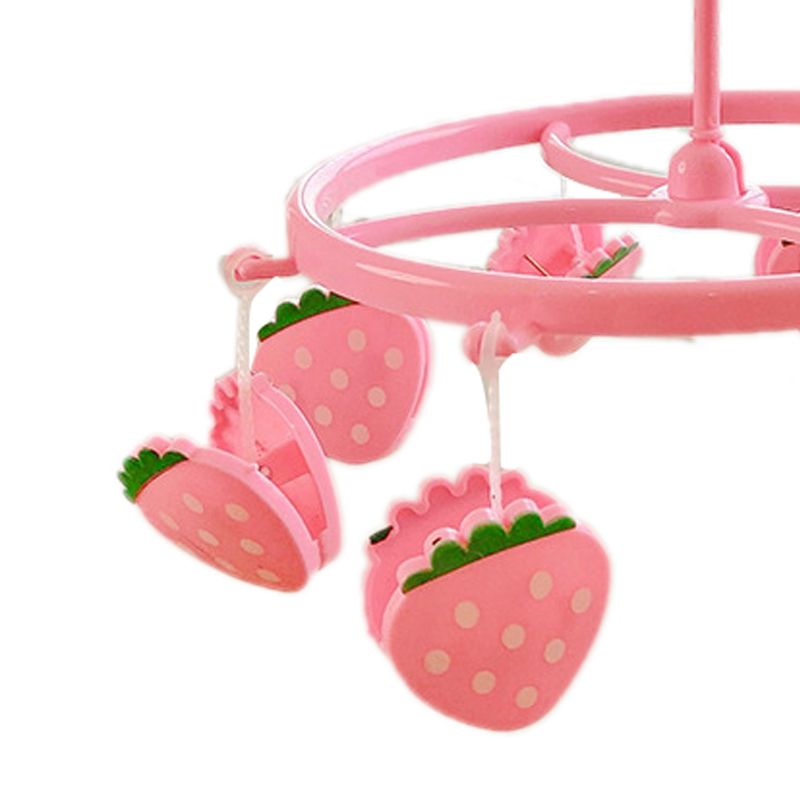 Pink plastic hanging drying rack with small cloth clips for socks and underwear, designed for kids' sleepwear storage.