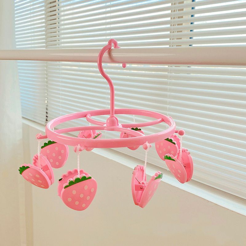 Pink plastic hanging drying rack with small cloth clips, designed for socks and underwear, ideal for home or dormitory use.