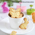 Set of four plastic fondant cutters with butterfly, rabbit, chick, and Easter egg shapes for cake decorating and biscuit making.