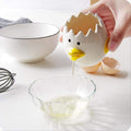 Ceramic chick-shaped egg yolk separator from Everything Baby, designed for kitchen use to easily separate egg yolks from whites.