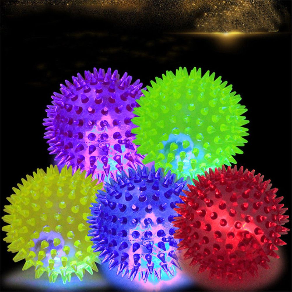 LED flashing PVC puppy and dog toy ball with spikes, suitable for playful chase and bouncing activities for pets and kids.