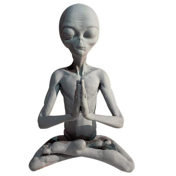 Garden art sculpture of a meditating extraterrestrial figurine by Everything Baby, suitable for outdoor or indoor garden and lawn decor.