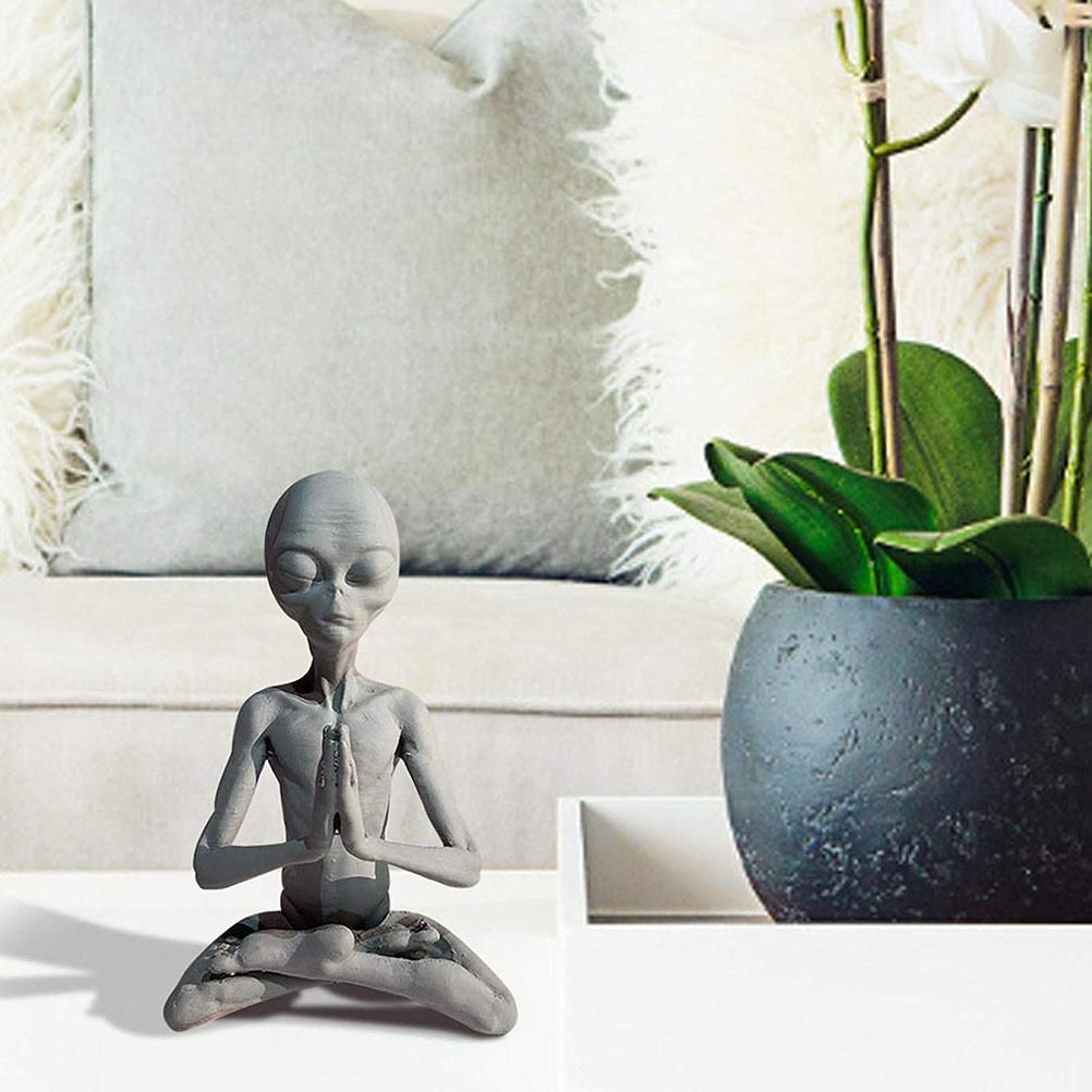 Meditating extraterrestrial garden sculpture by Everything Baby, outdoor lawn decor figure for home or garden space.