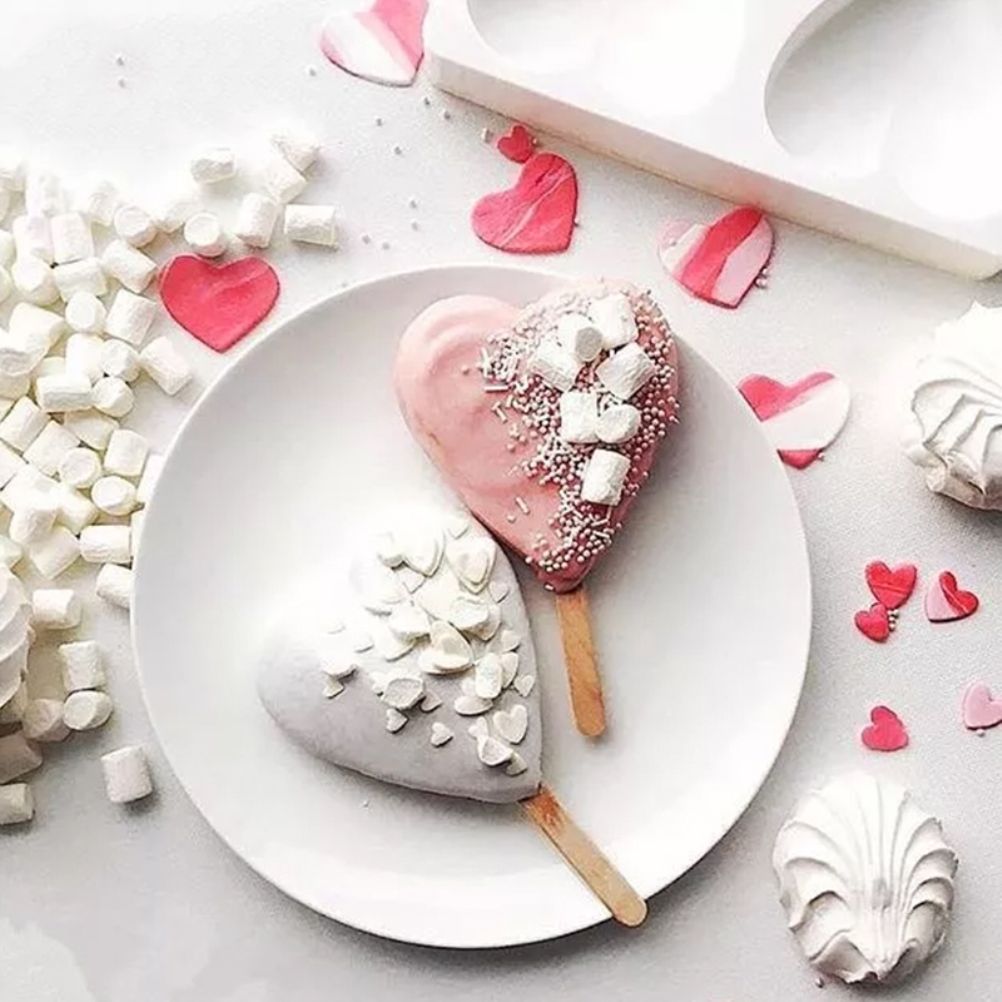 Heart-shaped paw silicone ice cream mold for making DIY popsicles, suitable for kids' pretend play and homemade treats.
