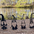 Cute outdoor garden metal statue of a standing goblin, decorative iron art for home garden or yard outdoor decor.