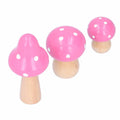 Set of three pink wooden mushroom ornaments, cute and innovative decor pieces for home or office desktop decoration.