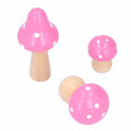 Set of three pink wooden mushroom ornaments from Everything Baby, cute crafts for home or office decor and children's building toys.