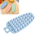 Blue carrot-shaped vegetable brush and potato scrubber for cleaning fruits and vegetables in the kitchen.