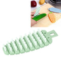 Green carrot-shaped vegetable and fruit scrubber brush for kitchen cleaning, designed for baby and kids feeding accessories.