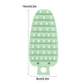 Green carrot-shaped vegetable brush for cleaning potatoes, fruits, and vegetables, designed for kitchen scrubbing and food prep.