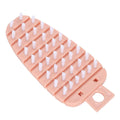 Pink carrot-shaped vegetable brush for scrubbing potatoes, fruits, and vegetables, ideal for kitchen cleaning and food prep.