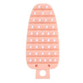 Pink carrot-shaped vegetable brush and potato scrubber, perfect for cleaning fruits and vegetables in the kitchen.