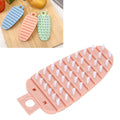 Pink carrot-shaped vegetable brush for cleaning potatoes and fruits, featuring soft bristles for kitchen scrubbing.
