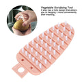 Pink carrot-shaped vegetable brush for scrubbing potatoes and fruits, ideal for kitchen cleaning from Everything Baby.