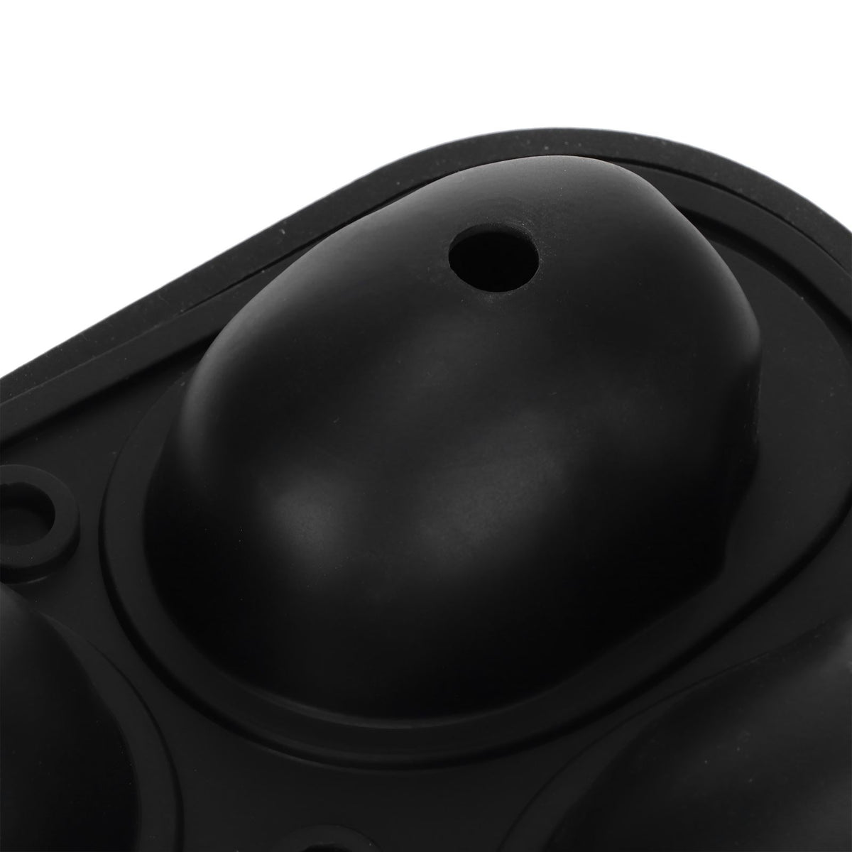 Silicone skull-shaped ice tray with two funnels, suitable for Halloween treats, in a kitchen setting.