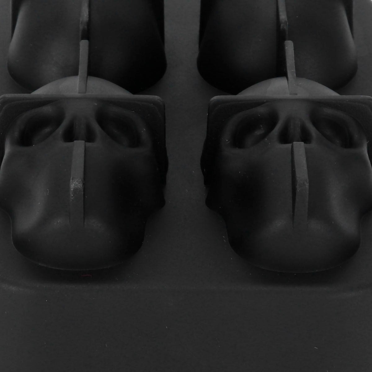 Silicone skull-shaped ice mold tray with irregular ice cubes, ideal for home bar, parties, and summer beverages.