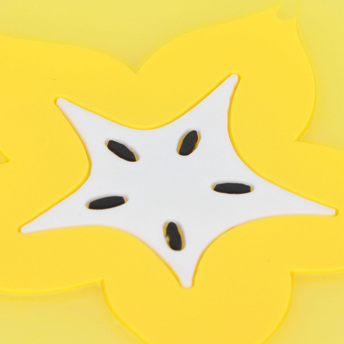 Silicone fruit-shaped coaster featuring a carambola design, ideal as a tableware placemat for drinks and kitchen accessories.