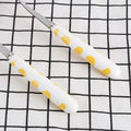 Two-piece stainless steel kid's flatware set with yellow handles, including knife, fork, and spoon in a box for children pretend play.