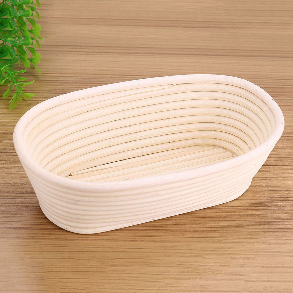 Handmade unbleached natural cane banneton proofing basket for bread dough, 25x14.5x8cm, used in baking bread at home.