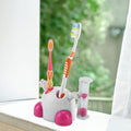 Pink children's toothbrush holder with built-in 3-minute sand timer for kids' brushing, designed for baby and kids' dental care.