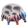 Silicone mold with hot air balloon pattern for fondant cake decoration, suitable for baby and kids' pretend play baking projects.