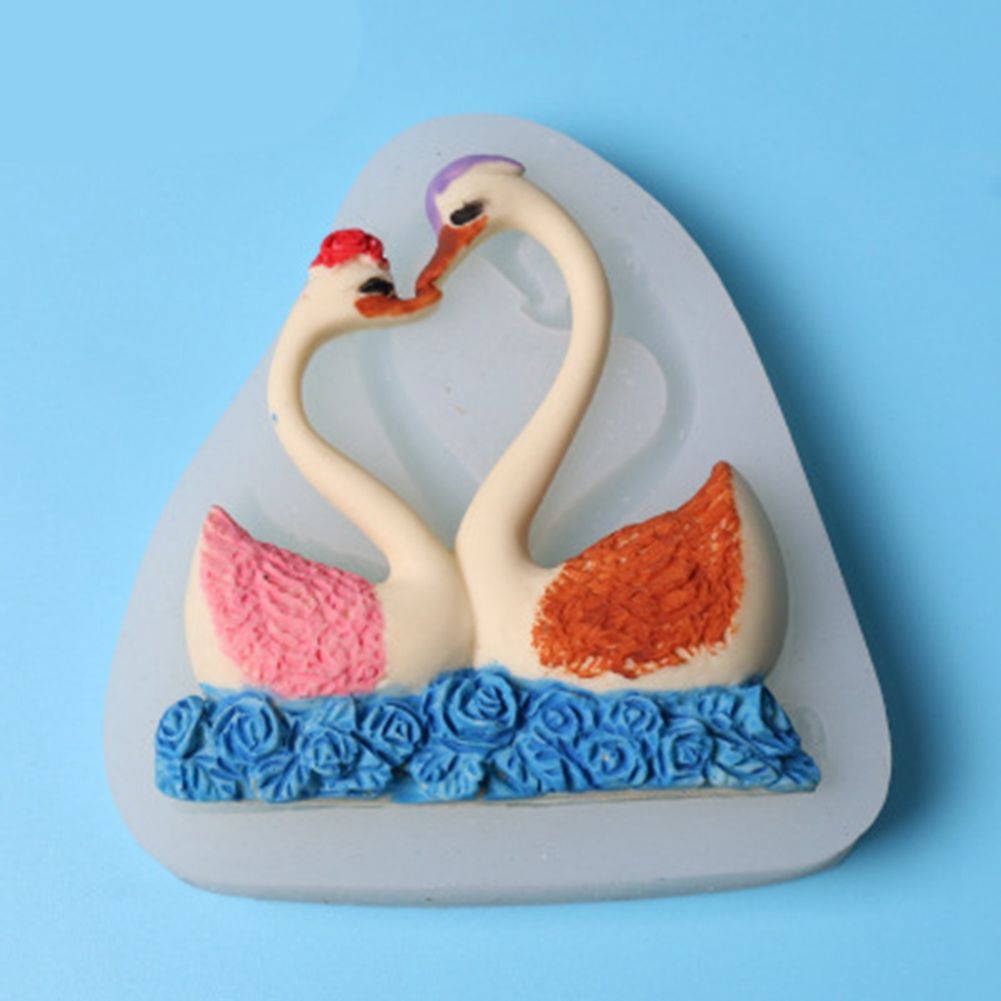 Silicone cake mold featuring a sweet couple swan pattern, ideal for baking desserts and chocolates for kids' pretend play.