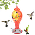 Colorful glass bird feeder with a bird-shaped design, suitable for outdoor gardens and attracting hummingbirds and garden birds.