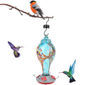 Colorful glass bird feeder with hummingbird design, outdoor garden water feeding tool, vibrant and decorative for garden bird watching