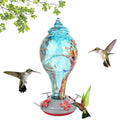 Colorful glass bird feeder with a hummingbird design, suitable for outdoor gardens and courtyards, by Everything Baby.