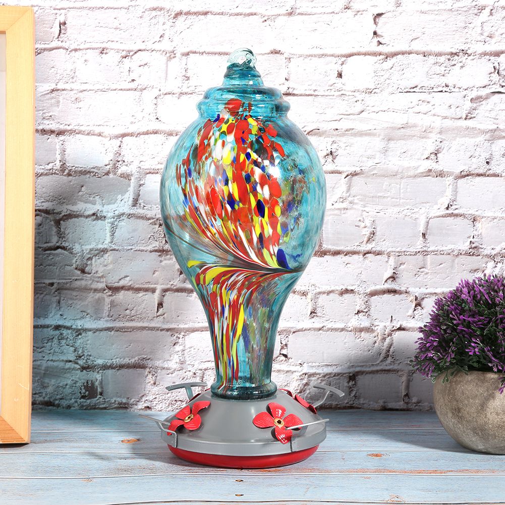 Colorful glass bird feeder with a bird design, suitable for outdoor gardens, attracting hummingbirds and garden birds.