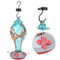 Colorful glass bird feeder with hummingbird design for outdoor gardens, featuring water and feeding ports, by Everything Baby.