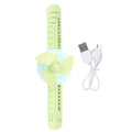 Green cartoon watch-shaped mini kid wrist fan with adjustable strap, USB rechargeable, suitable for children.