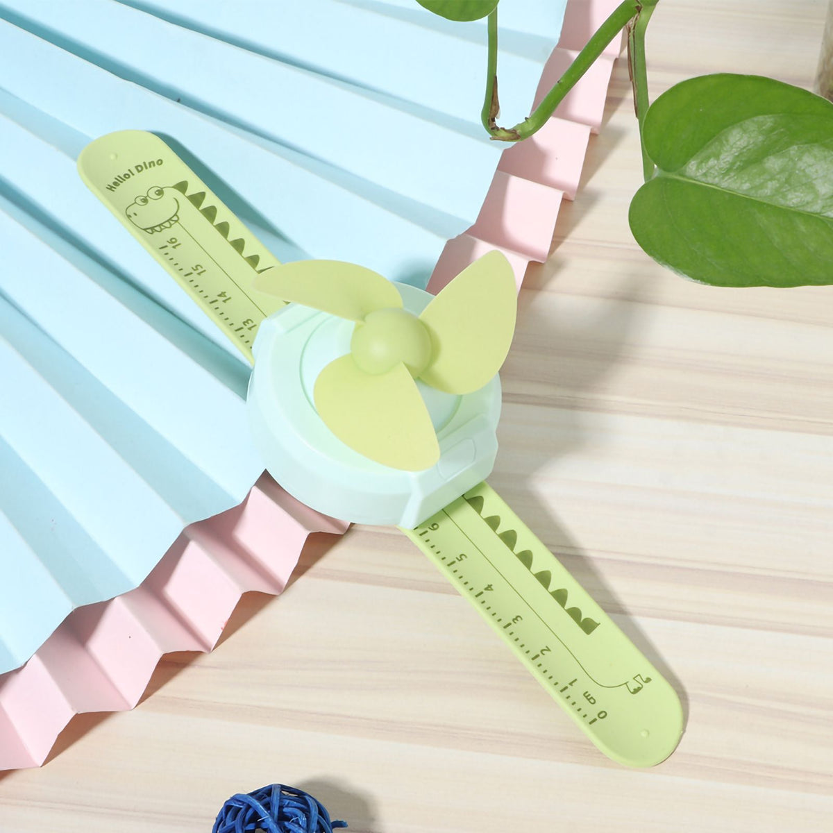 Green cartoon watch-shaped mini kids' wrist fan with adjustable strap, USB charging, ideal for children, by Everything Baby.