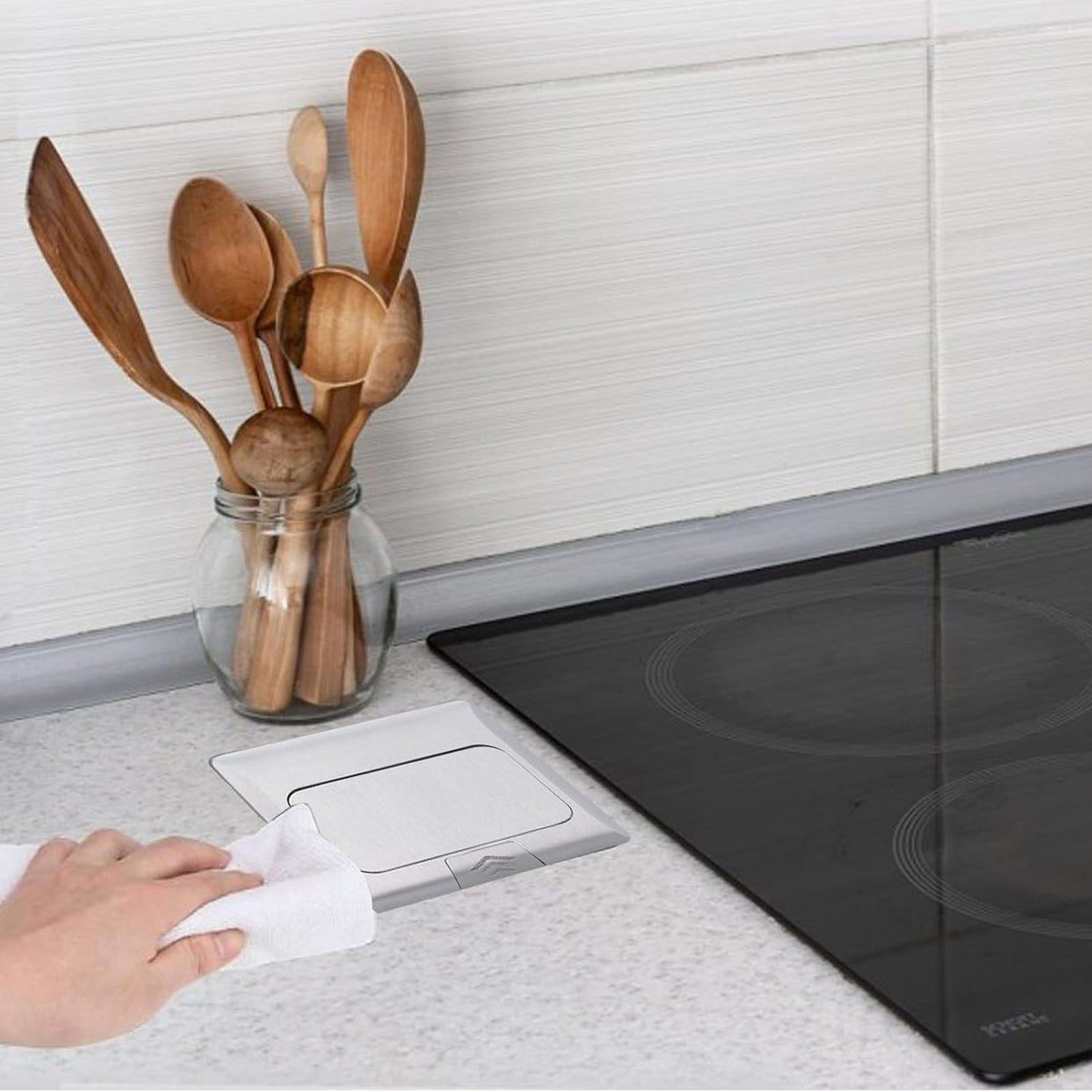 Pop up floor outlet box from Everything Baby with waterproof USB ports on a kitchen countertop, embedded and weatherproof for outdoor use.