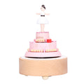 Wooden music box with girl figure, designed for kids' pretend play, featuring a birthday cake motif and crafted wooden decorations.