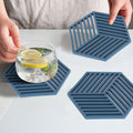 Blue hexagonal stripe heat-insulated coasters for dining tables, perfect for protecting surfaces from hot cups and tableware.