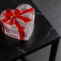 Glass heart-shaped candy jar with red bow lid, clear cookie bowl for snacks, jewelry, and storage, by Everything Baby.